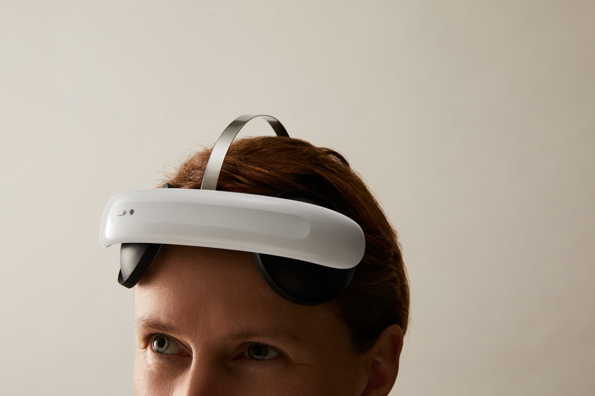 A person wearing the Flow brain-stimulation headset at home